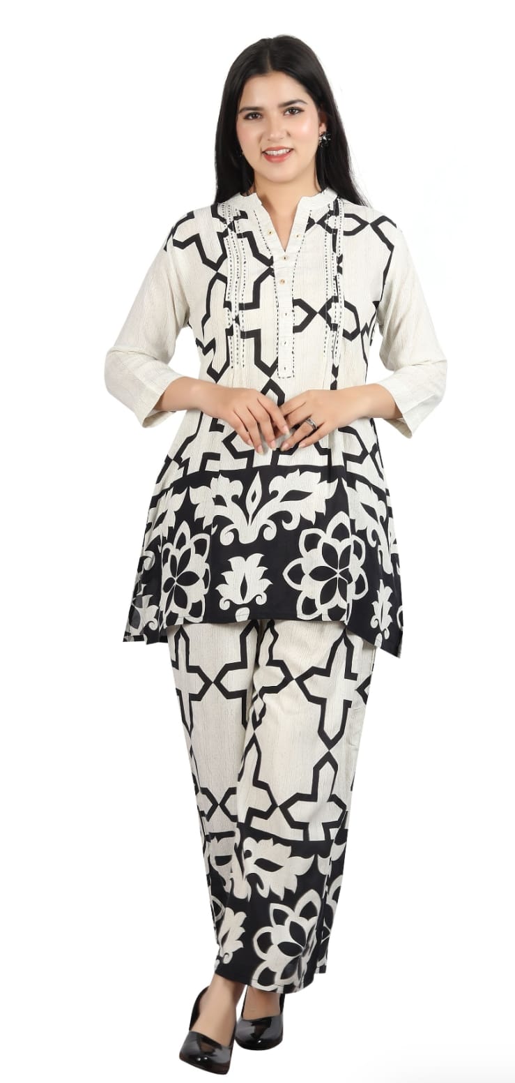 Woman wearing a black and white patterned outfit on a white background