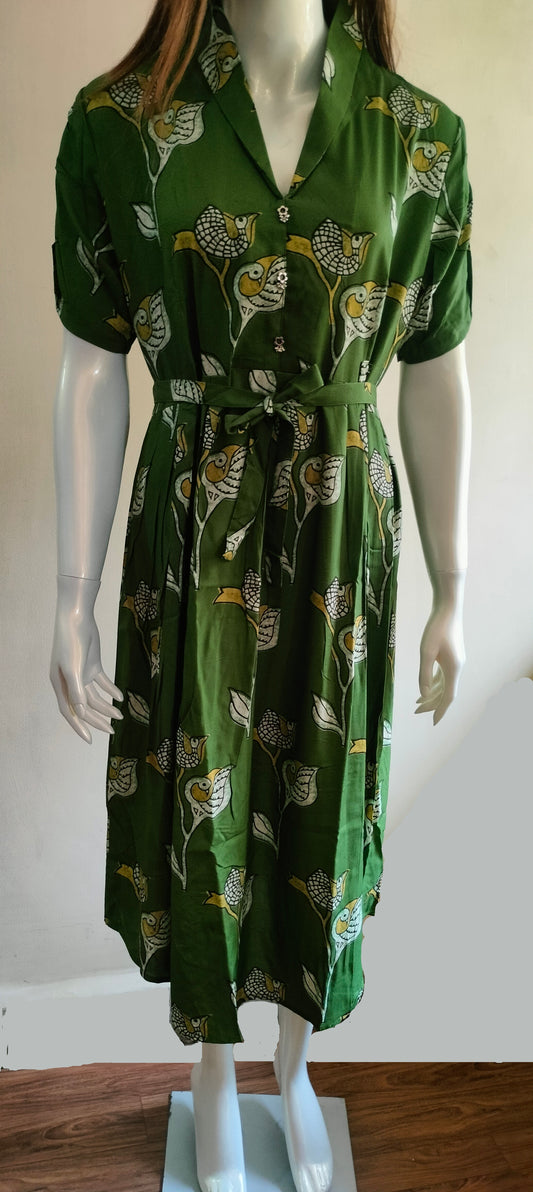 Green dress with a pattern on a mannequin against a white background