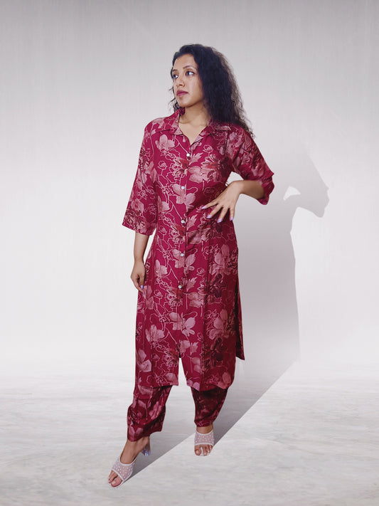 Woman wearing a red floral outfit on a white background
