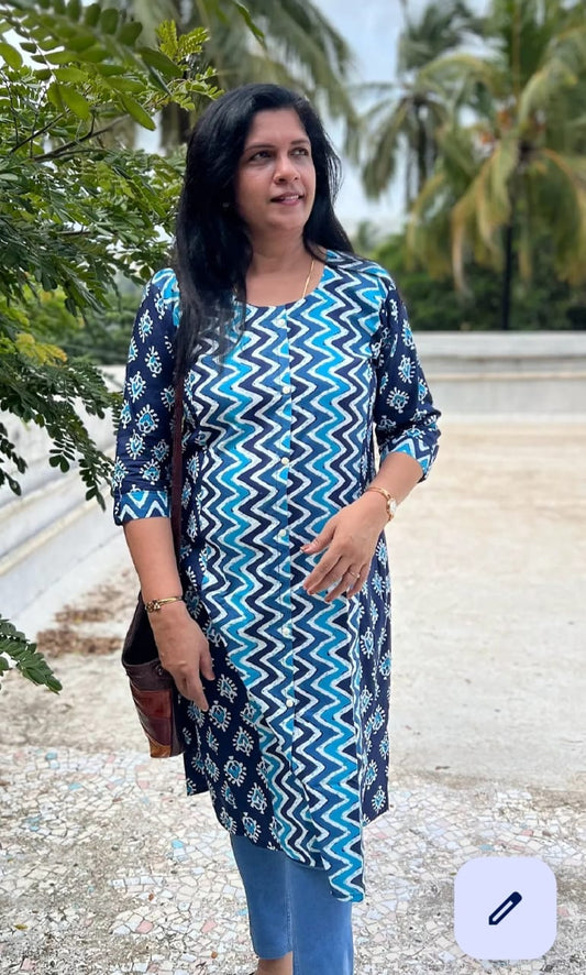 blue and black patterned dress against a natural background